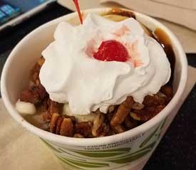 vacation ice cream - Freddy's Frozen Custard Pecan Caramel Turtle Sundae with a cherry on top.