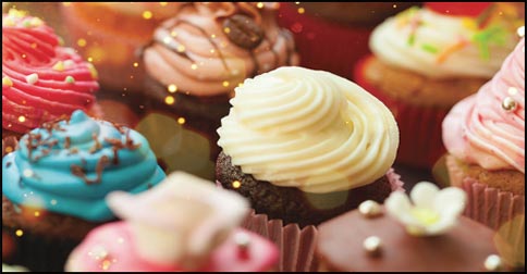 array of brightly decorated cupcakes with sparkles and sprinkles