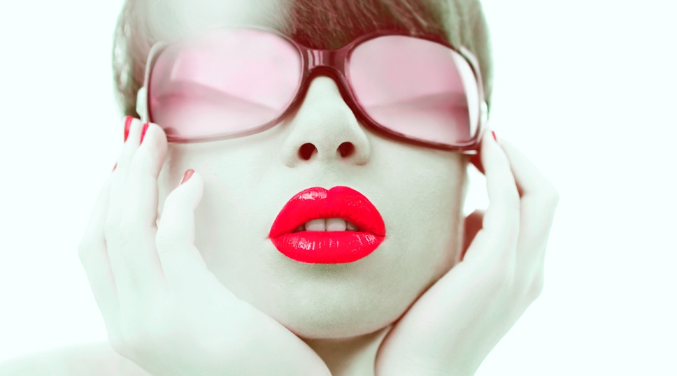 Glamour photo of red lipstick and red sunglasses of young woman