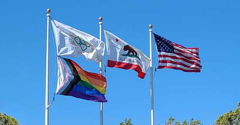 Pride weeks flags Progress, Rainbow, Dublin, California, United States flags photo by Karin Kallmaker