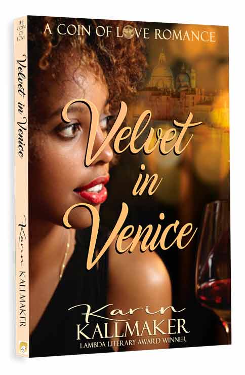 A glowing young black woman with natural hair and red lips looks over her should through mottled light at the Grand Canal and skyline of St. Marcos Plaza in Venice. A glass of deep red wine is in the foregound. Text reads A Coin of Love Romance, Velvet in Venice, Karin Kallmaker, Goldie and Lammy Winning Author