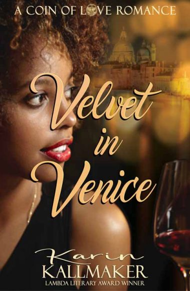 A glowing young black woman with natural hair and red lips looks over her shoulder through mottled light at the Grand Canal and skyline of St. Marcos Plaza in Venice. A glass of deep red wine is in the foregound. A Coin of Love Romance, Velvet in Venice, Karin Kallmaker, Goldie and Lammy Winning Author