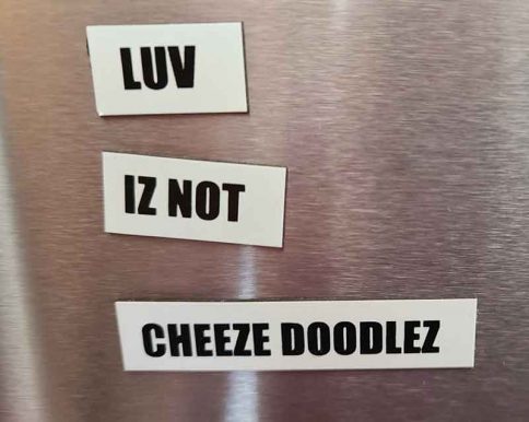 refrigerator magnets with black type on white background read LUV IZ NOT CHEEZE DOODLEZ
