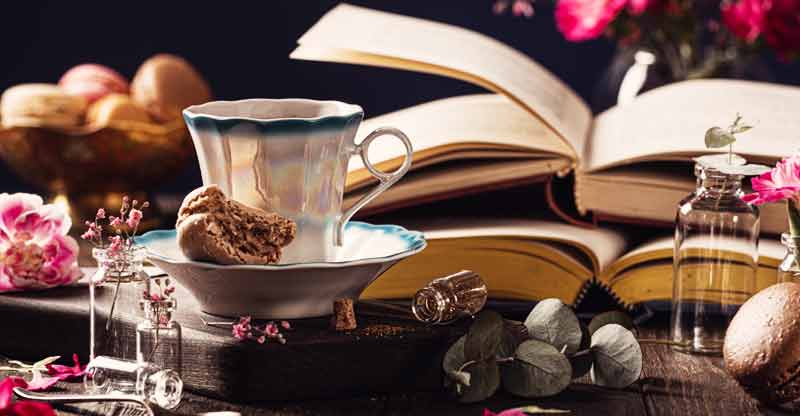 coffee old books pink flowers and snacks