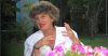 Joan Nestle speaking at table with flowers