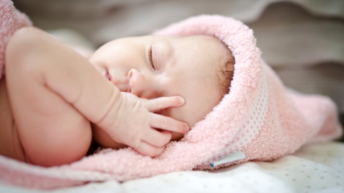 sleeping baby in pink fuzzy