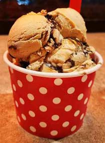 Familiar pink polka dot Zoey's cup filled with luscious peanut butter chocolate, Oreo cookie coffee caramel, and cuppucino fudge ice creams